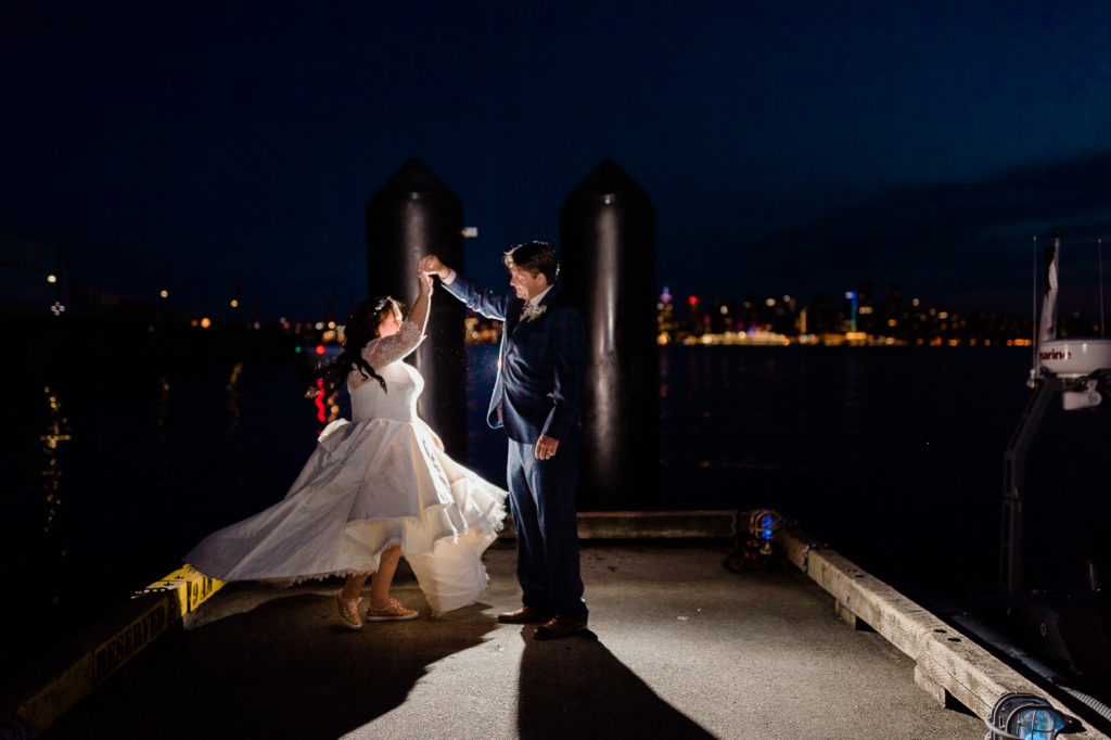 Choosing your wedding photographer, couple dancing on the pier.