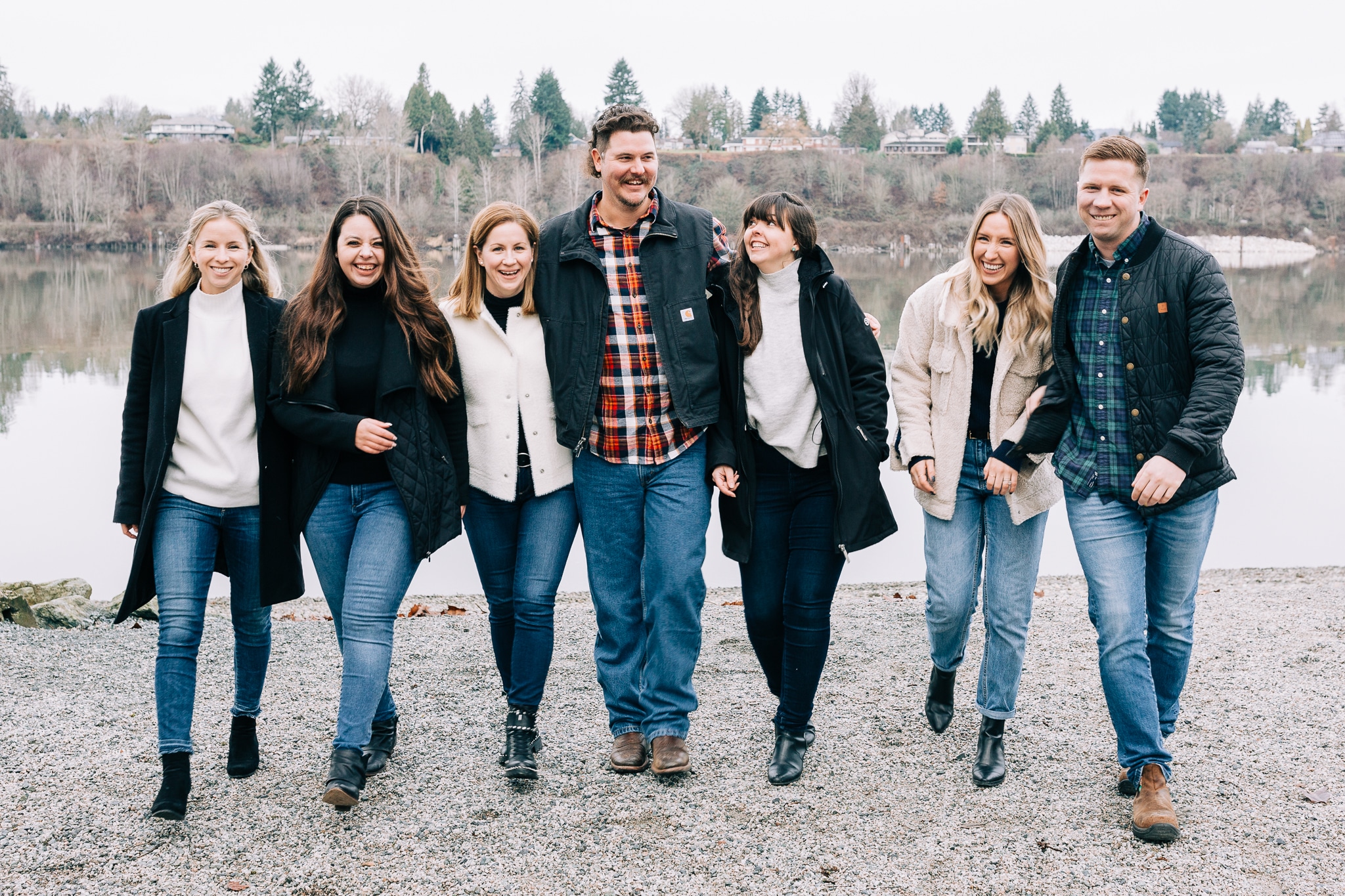Group of adults walking towards camera, talking and laughing